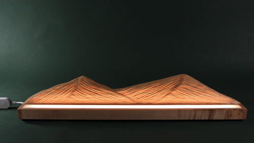 Wooden mountain-shaped lamp on a dark background